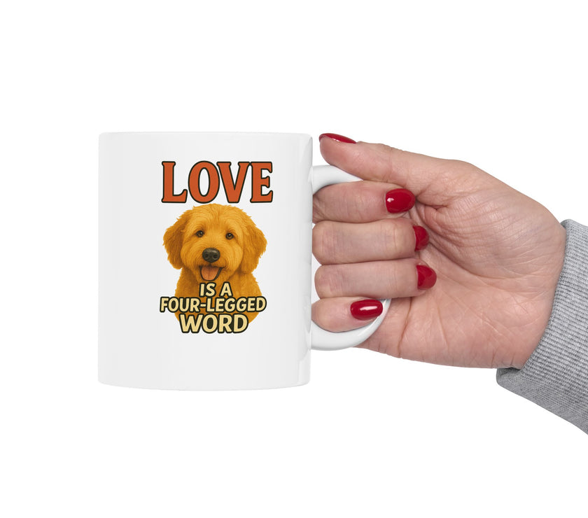 Mug with a dog illustration and text 'Love is a four-legged word' held by a hand.