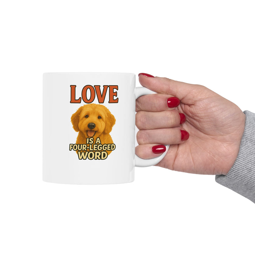 Mug with a dog illustration and text 'Love is a four-legged word' held by a hand.