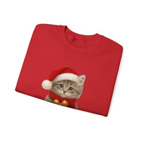 Red folded sweatshirt featuring a gray kitten wearing a Santa hat and red scarf, holding a small red gift box with a gold bow, surrounded by snowflake designs.