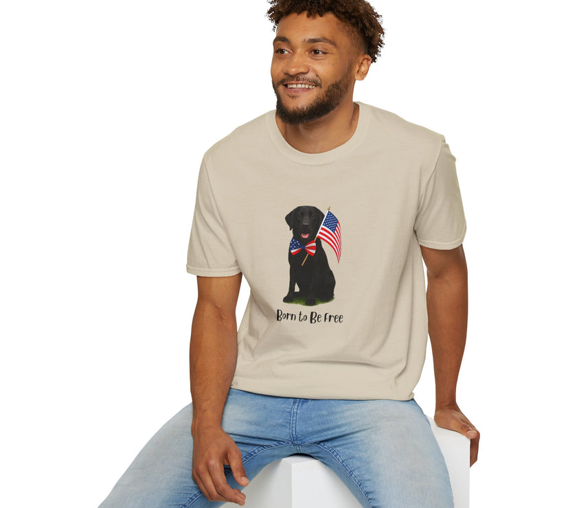 Sand t-shirt featuring a patriotic Black Lab wearing an American flag bowtie and holding U.S. flags, with the Black Labphrase "Born to Be Free" printed below — perfect for dog lovers and patriotic Americans.