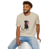 Sand t-shirt featuring a patriotic Black Lab wearing an American flag bowtie and holding U.S. flags, with the Black Labphrase "Born to Be Free" printed below — perfect for dog lovers and patriotic Americans.