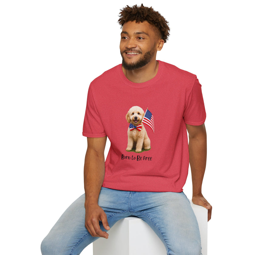 Male wearing T-shirt featuring a cute golden doodle puppy wearing an American flag bow tie and holding a small U.S. flag, with the phrase 'Born to Be Free' printed below the image.