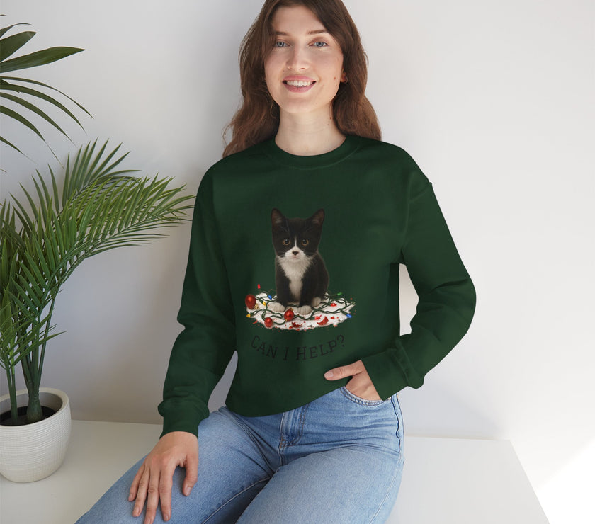Woman wearing a green sweatshirt with a cat design, sitting on a white surface with a plant in the background.