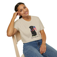 Sand t-shirt featuring a patriotic Black Lab wearing an American flag bowtie and holding U.S. flags, with the Black Labphrase "Born to Be Free" printed below — perfect for dog lovers and patriotic Americans.