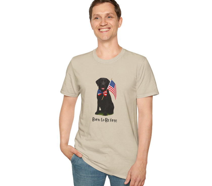 Sand t-shirt featuring a patriotic Black Lab wearing an American flag bowtie and holding U.S. flags, with the Black Labphrase "Born to Be Free" printed below — perfect for dog lovers and patriotic Americans.