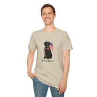 Sand t-shirt featuring a patriotic Black Lab wearing an American flag bowtie and holding U.S. flags, with the Black Labphrase "Born to Be Free" printed below — perfect for dog lovers and patriotic Americans.