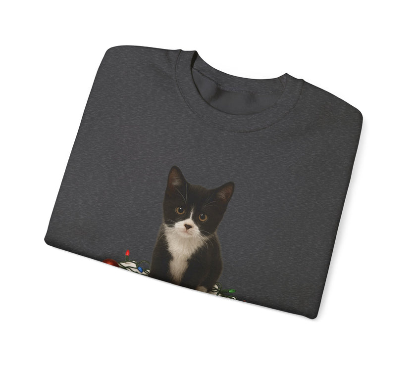 Folded dark gray t-shirt with a black and white cat graphic on a white background