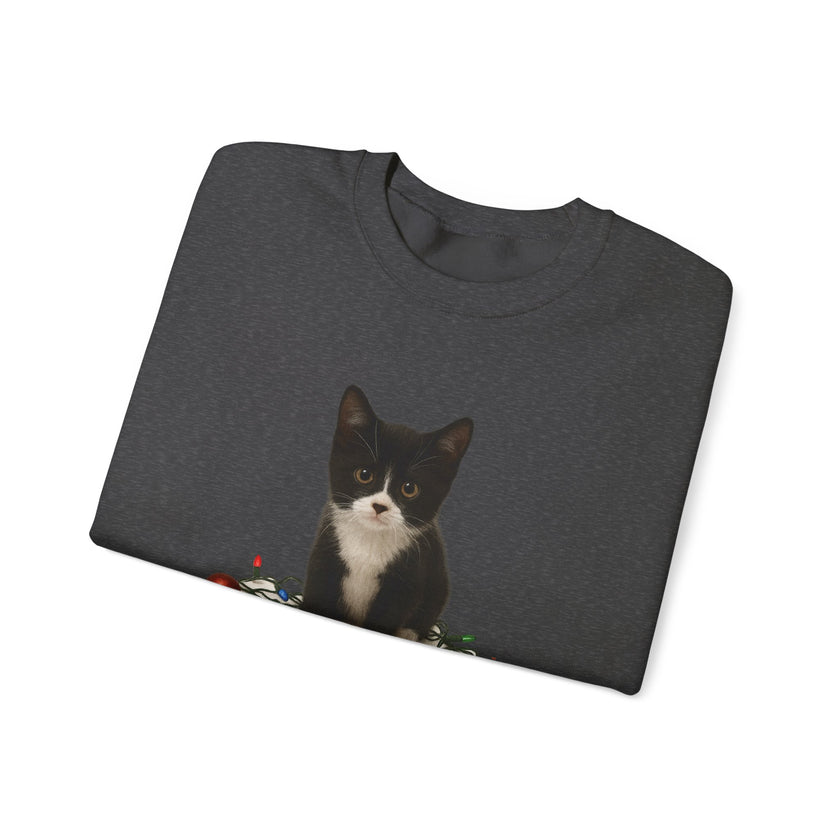 Folded dark gray t-shirt with a black and white cat graphic on a white background