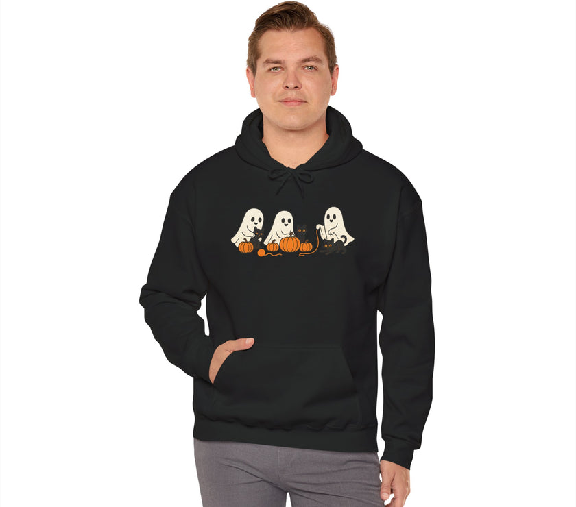 Person wearing a black hoodie with Halloween-themed design on a white background