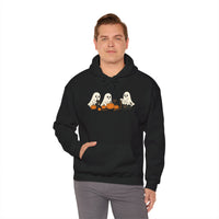 Person wearing a black hoodie with Halloween-themed design on a white background