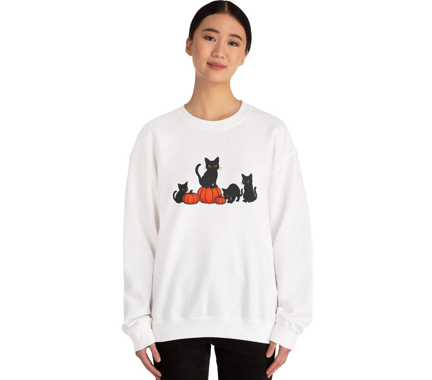 White sweatshirt with black cat and pumpkin design worn by a person on a white background