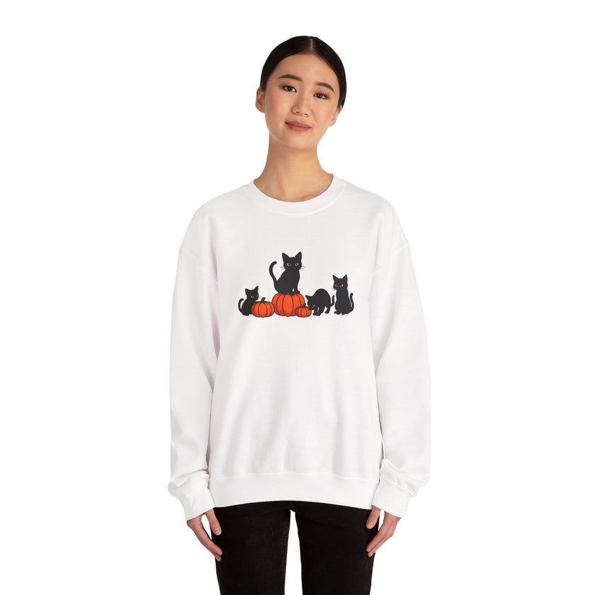 White sweatshirt with black cat and pumpkin design worn by a person on a white background