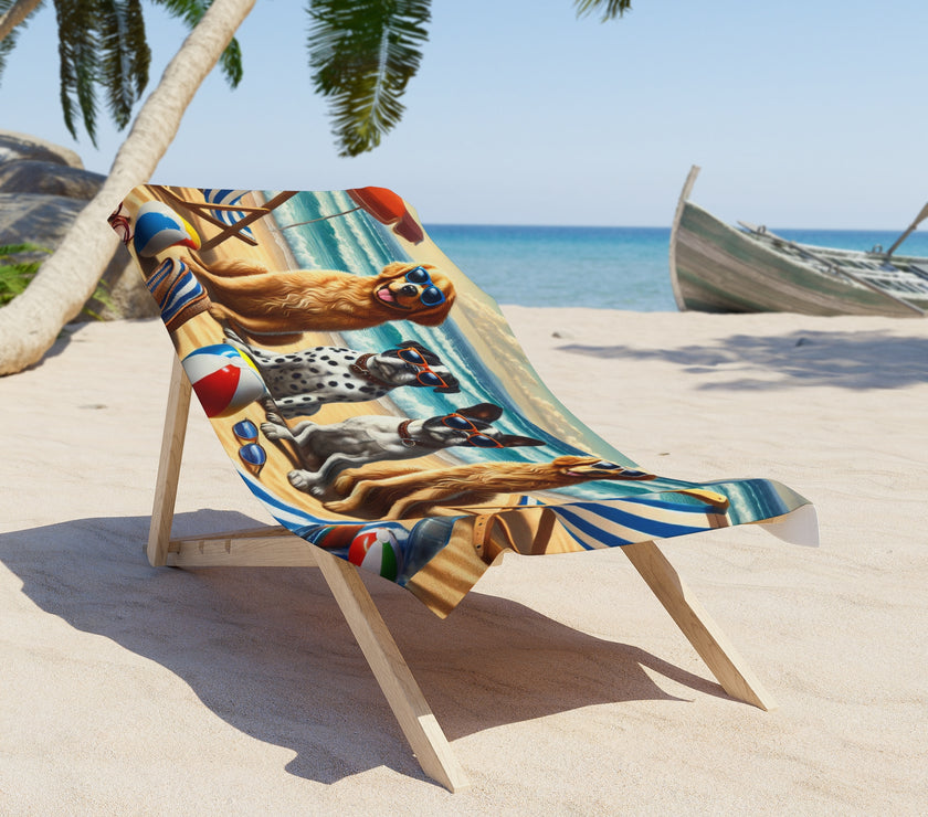 Colorful beach towel featuring four stylish dogs wearing sunglasses, sitting on a sandy beach with beach chairs, beach balls, and ocean waves in the background under a bright sky.