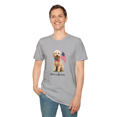 Male wearing T-shirt featuring a cute golden doodle puppy wearing an American flag bow tie and holding a small U.S. flag, with the phrase 'Born to Be Free' printed below the image.