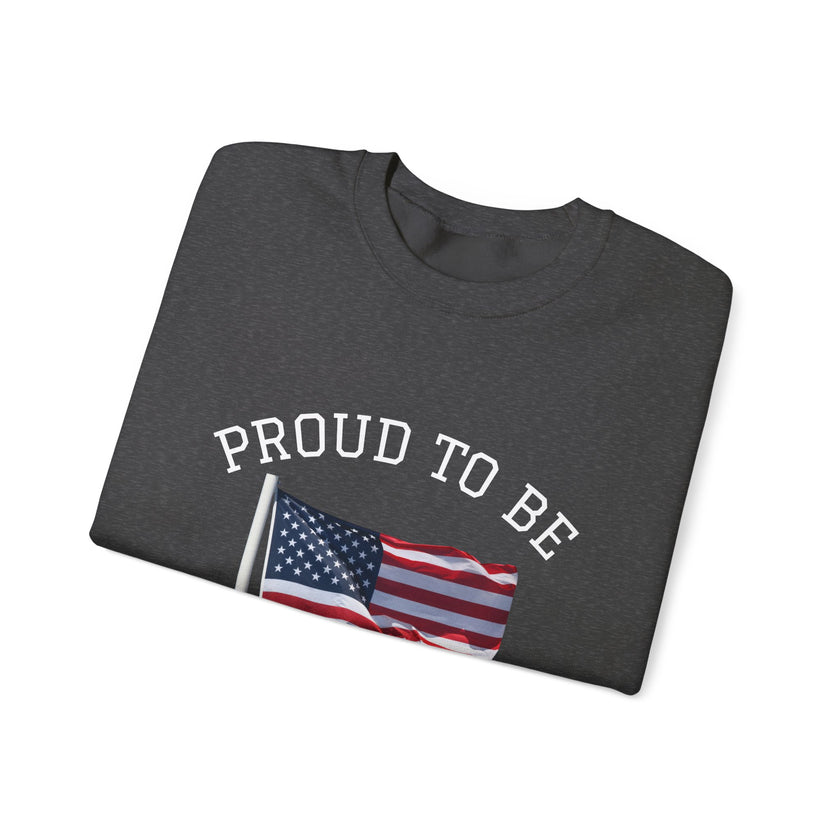 Folded dark gray t-shirt with 'PROUD TO BE' text and American flag design on a white background