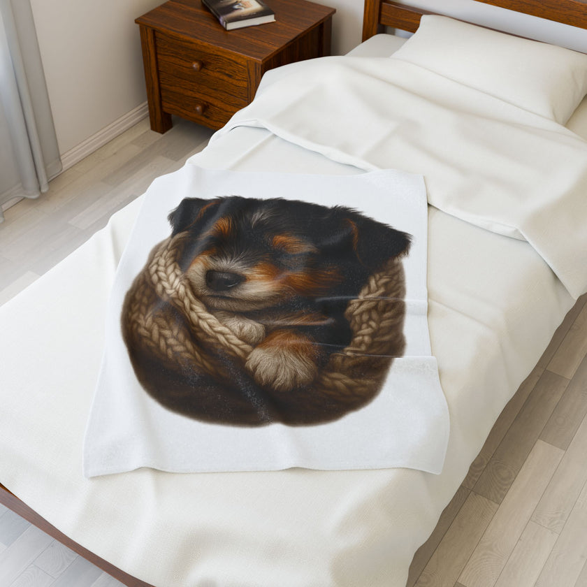 Blanket with a dog design draped over a bed in a bedroom setting.