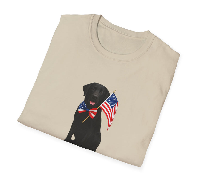 Sand t-shirt featuring a patriotic Black Lab wearing an American flag bowtie and holding U.S. flags, with the Black Labphrase "Born to Be Free" printed below — perfect for dog lovers and patriotic Americans.