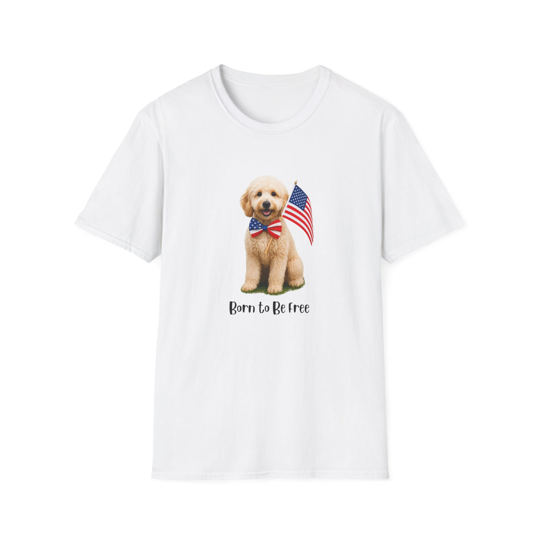 White t-shirt featuring a cute golden doodle puppy wearing an American flag bow tie and holding a small U.S. flag, with the phrase 'Born to Be Free' printed below the image.