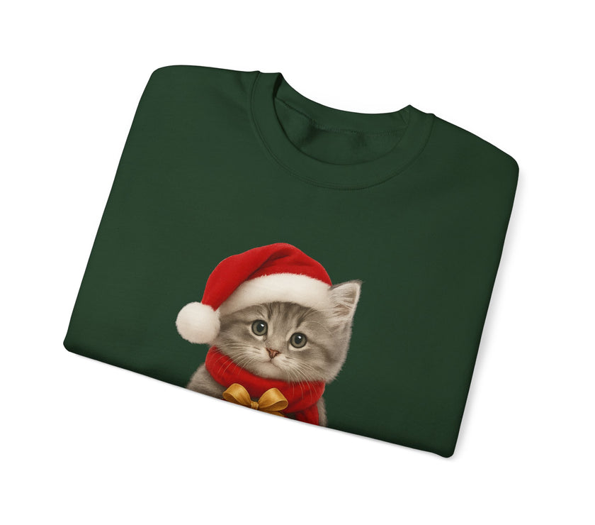 Green folded sweatshirt featuring a gray kitten wearing a Santa hat and red scarf, holding a small red gift box with a gold bow, surrounded by snowflake designs.