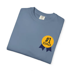 Jean color t-shirt featuring a yellow and navy blue award ribbon graphic on the chest with the text "#1 Dad," designed as a fun and heartfelt Father's Day gift.
