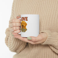 Person holding a mug with a dog illustration and text 'LOVE is a four-legged word' against a beige background