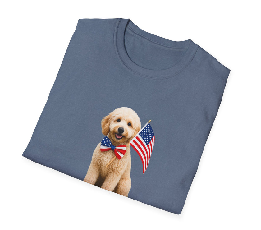 Folded T-shirt featuring a cute golden doodle puppy wearing an American flag bow tie and holding a small U.S. flag, with the phrase 'Born to Be Free' printed below the image.