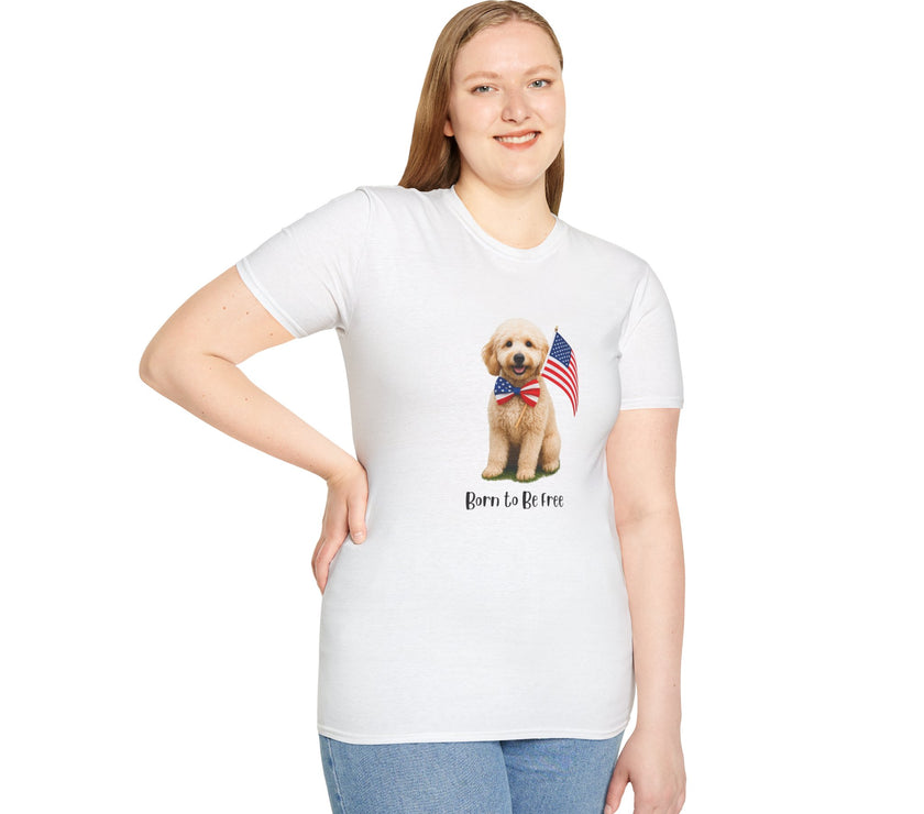 Female wearing T-shirt featuring a cute golden doodle puppy wearing an American flag bow tie and holding a small U.S. flag, with the phrase 'Born to Be Free' printed below the image.