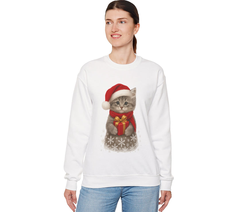 White sweatshirt featuring a gray kitten wearing a Santa hat and red scarf, holding a small red gift box with a gold bow, surrounded by snowflake designs.