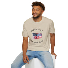 Young man  wearing a white t-shirt with an American flag graphic and the words 'Proud to Be an American' printed around the flag