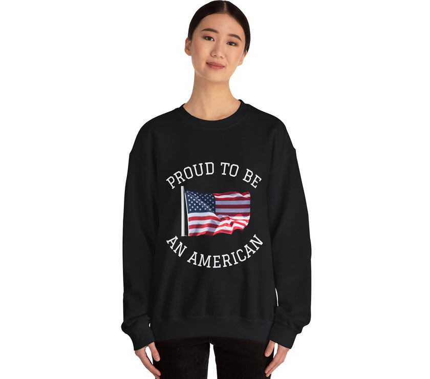 Black sweatshirt with American flag and text 'Proud to be an American' worn by a person on a white background