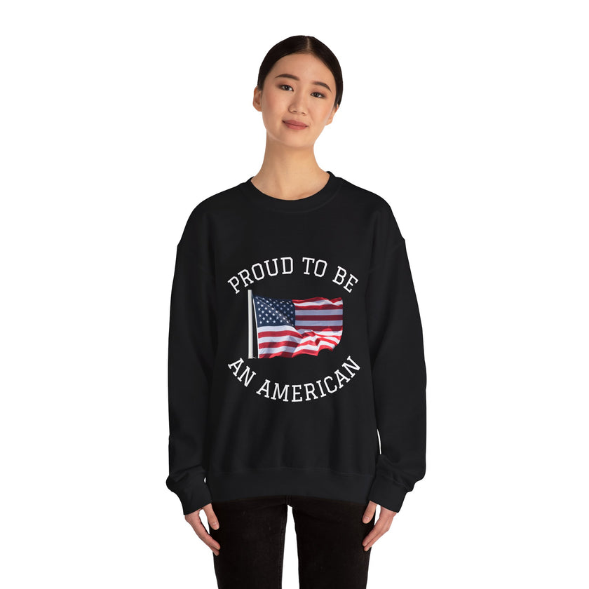 Black sweatshirt with American flag and text 'Proud to be an American' worn by a person on a white background