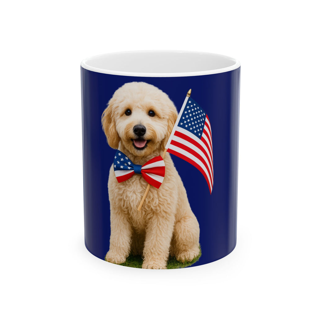 A ceramic mug featuring aGoldendoodle sitting on grass, wearing a red, white, and blue bow tie, and holding an American flag against a dark blue background. with the message "Born to be Free"
