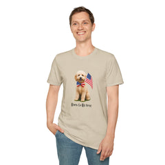 Male wearing T-shirt featuring a cute golden doodle puppy wearing an American flag bow tie and holding a small U.S. flag, with the phrase 'Born to Be Free' printed below the image.