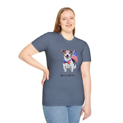 Female wearing T-shirt featuring a cute  puppy wearing an American flag bow tie and holding a small U.S. flag, with the phrase 'Born to Be Free' printed below the image.