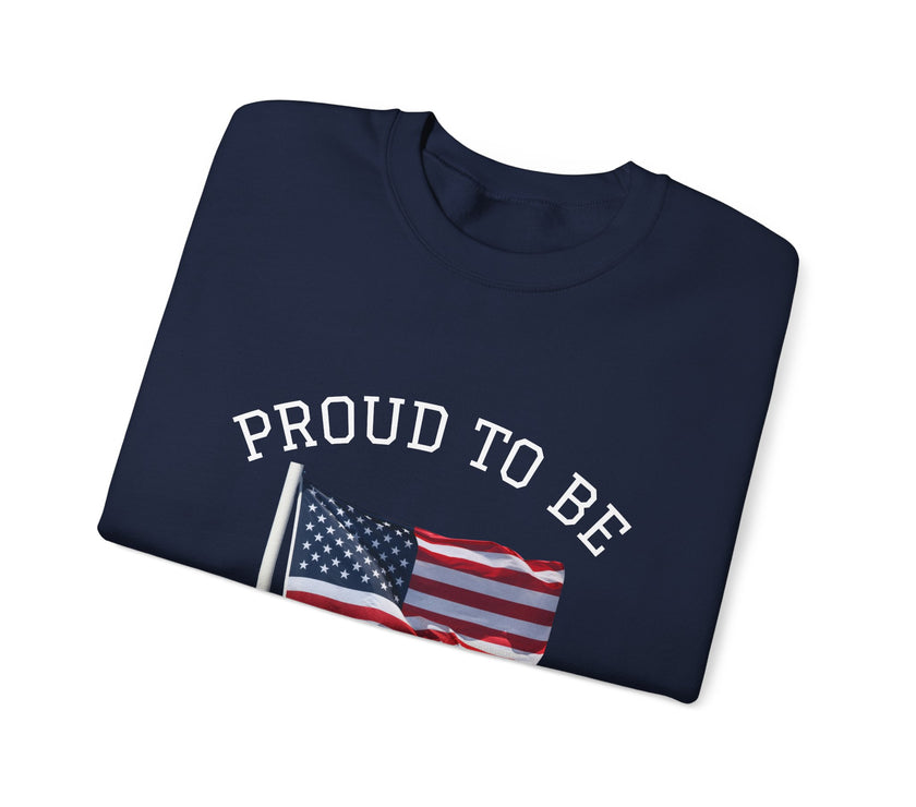 Folded navy blue sweatshirt with 'PROUD TO BE' text and American flag on a white background