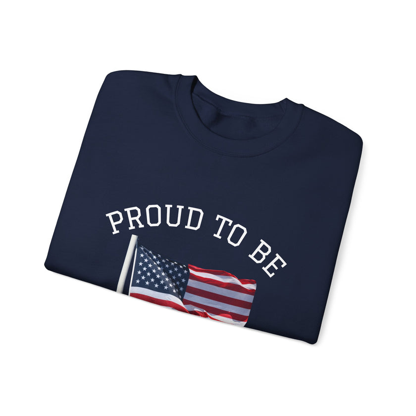 Folded navy blue sweatshirt with 'PROUD TO BE' text and American flag on a white background