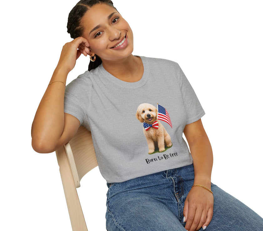 Female wearing T-shirt featuring a cute golden doodle puppy wearing an American flag bow tie and holding a small U.S. flag, with the phrase 'Born to Be Free' printed below the image.