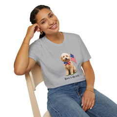 Female wearing T-shirt featuring a cute golden doodle puppy wearing an American flag bow tie and holding a small U.S. flag, with the phrase 'Born to Be Free' printed below the image.