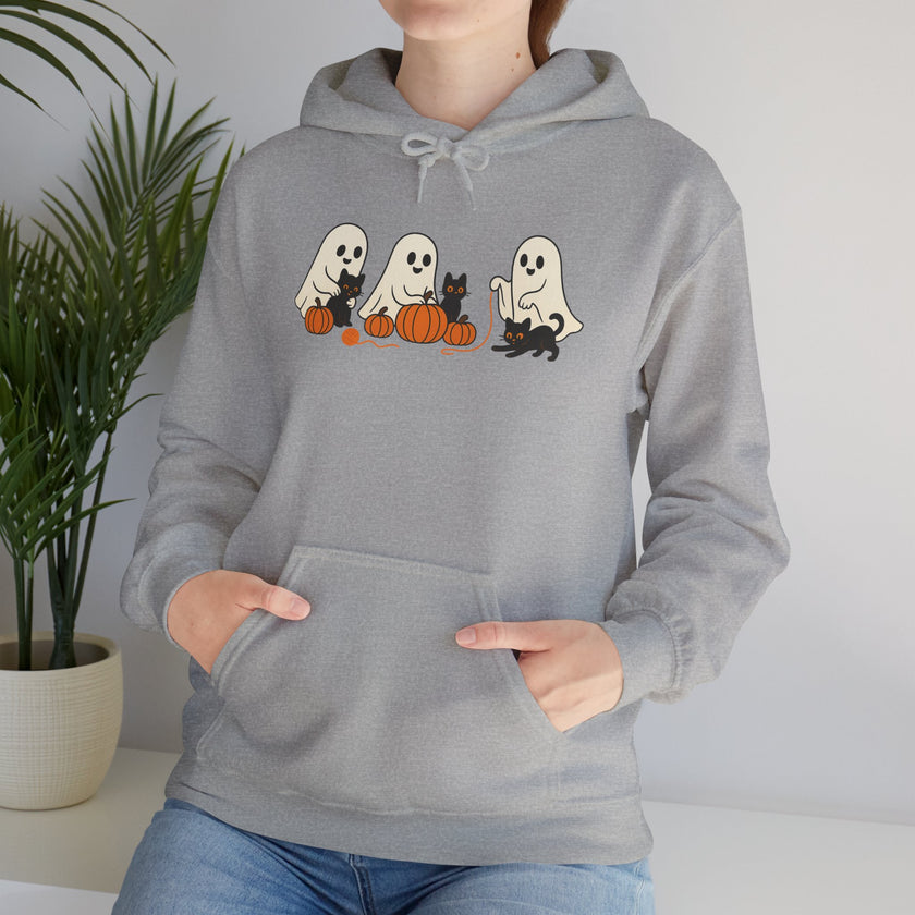 Person wearing a gray hoodie with Halloween-themed design featuring ghosts, cats, and pumpkins.