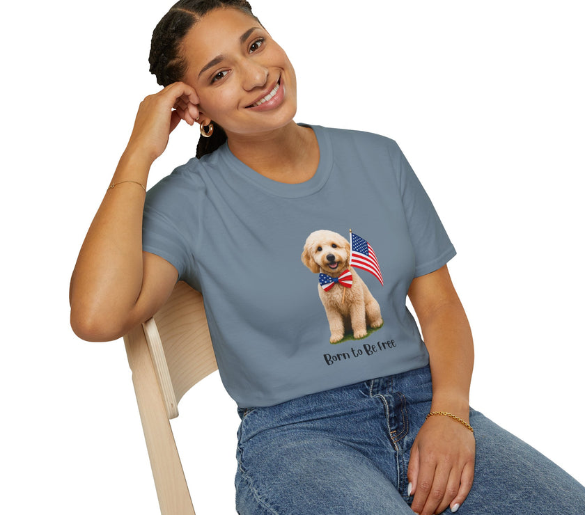 Female wearing T-shirt featuring a cute golden doodle puppy wearing an American flag bow tie and holding a small U.S. flag, with the phrase 'Born to Be Free' printed below the image.