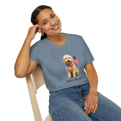 Female wearing T-shirt featuring a cute golden doodle puppy wearing an American flag bow tie and holding a small U.S. flag, with the phrase 'Born to Be Free' printed below the image.