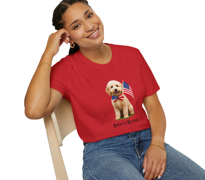 Female wearing T-shirt featuring a cute golden doodle puppy wearing an American flag bow tie and holding a small U.S. flag, with the phrase 'Born to Be Free' printed below the image.