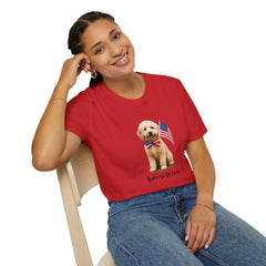 Female wearing T-shirt featuring a cute golden doodle puppy wearing an American flag bow tie and holding a small U.S. flag, with the phrase 'Born to Be Free' printed below the image.