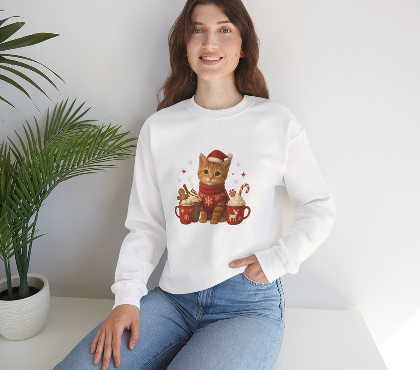 Woman wearing a white sweatshirt with a Christmas-themed cat design, sitting in a room with a plant.