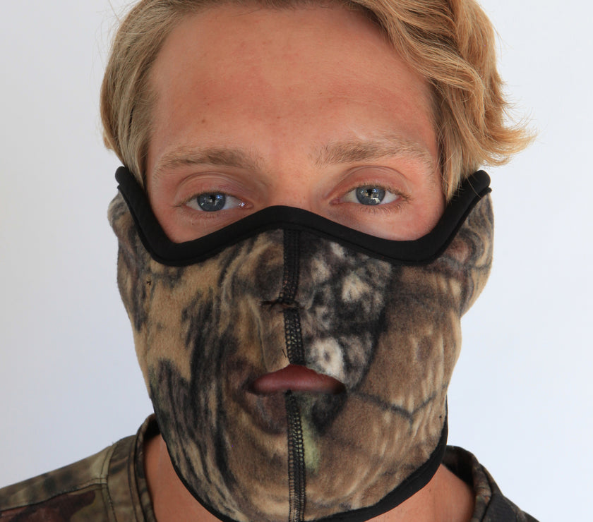 Person wearing a camouflage balaclava with a white background
