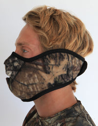 Person wearing a camouflage face mask on a white background