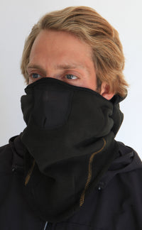 Person wearing a full-face black fleece balaclava with pockets for disposable air-activated warmers on a white background