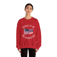Red sweatshirt with American flag and 'Proud to be an American' text worn by a person on a white background