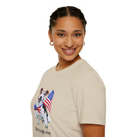 Female wearing T-shirt featuring a cute  puppy wearing an American flag bow tie and holding a small U.S. flag, with the phrase 'Born to Be Free' printed below the image.