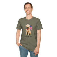 Male wearing T-shirt featuring a cute golden doodle puppy wearing an American flag bow tie and holding a small U.S. flag, with the phrase 'Born to Be Free' printed below the image.